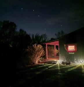 a house lit up at night with lights on it at The Barn House in Eureka Springs