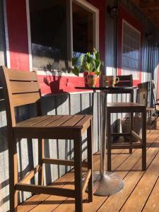 a table and two chairs on a porch with a table and a table and chairs at The Barn House in Eureka Springs