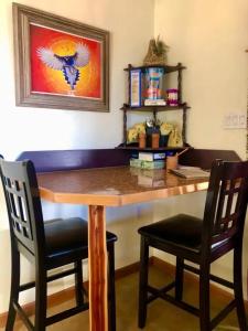 a wooden table with two chairs in a room at The Barn House in Eureka Springs