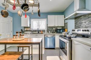 a kitchen with white cabinets and a wooden table at Tranquil Oasis in Lakeview in Mississauga