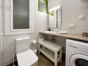 a white bathroom with a sink and a toilet at Stay U-nique Apartments Fira BCN in Hospitalet de Llobregat +19 photos