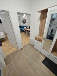 a room with a kitchen and a living room at Apartman Branko in Pale