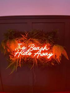 a neon sign that says no beach hideaway at Hot Tub, King Bed, Central, Modern Beach House in Cleethorpes