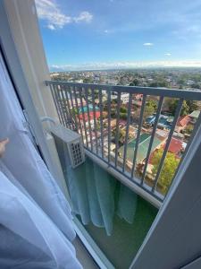 Cette chambre dispose d'un balcon offrant une vue sur la ville. dans l'établissement Serene Skyline Escape Las Pinas, à Manille