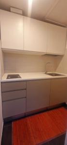 a kitchen with white cabinets and a sink at 108 APARTMENT - Torino in Turin