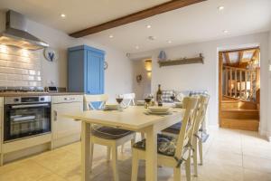 a kitchen with a wooden table and chairs in a room at Seaview Cottage in Hunstanton