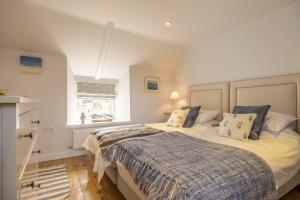 a bedroom with two beds and a window at Seaview Cottage in Hunstanton