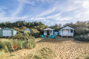 a group of cottages on a sandy beach at Seaview Cottage in Hunstanton