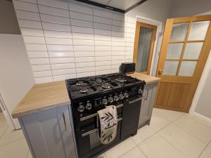 a kitchen with a black stove and a counter at Airfield Manor in Castle Donington