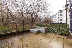 a bench sitting on top of a patio at Stunning 1 BD flat in Lochend Park with a patio in Edinburgh