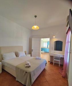 a bedroom with a bed and a desk in it at Castelli Studios in Astypalaia Town