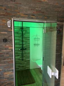 a bathroom with a shower with a glass door at Rêves de vie le "port pin" vue mer, petite piscine, jacuzzi, parking PRIVES in Cassis