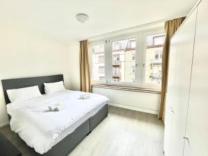 ein Schlafzimmer mit einem Bett und einem großen Fenster in der Unterkunft Urban Oasis with Queen Bed and View BE-18 in Zürich