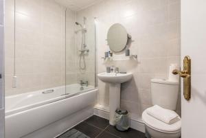 a bathroom with a sink and a toilet and a shower at 3 Bed Apartment - Perfect for Contractors near Liverpool Airport in Hale
