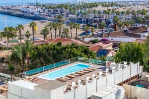 an aerial view of a building with a swimming pool and a beach at Ocean House 1713 By IVI Real Estate in Torremolinos