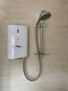 a shower with a shower head in a bathroom at Cosy 2 bedroom house in the heart of Morpeth in Morpeth