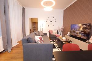 a living room with two couches and a tv at Ruby holiday home with patio in Vienna