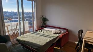 a bed in a room with a large window at TILLON -Lumineux Balcon Transports- in Aubervilliers