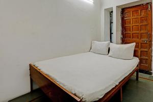 a bed with two pillows on it in a room at OYO Hotel Neelkamal palace and Guest house in Nāthdwāra