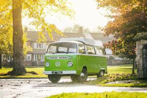 an old green van parked in a driveway at eDub Indie - The 100% Electric Classic Camper in Great Ouseburn