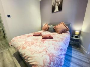 a bedroom with a large bed with pillows on it at Recently Refurbished Two Bedroom Apartment, Central Location! in Glasgow