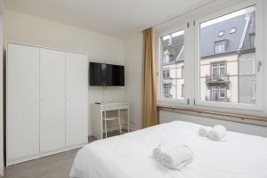 Postelja oz. postelje v sobi nastanitve Urban Oasis with Queen Bed and View BE-48