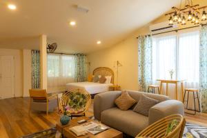 a living room with a couch and a bed at Sutera Sanctuary Lodges At Poring Hot Springs in Ranau