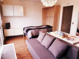a living room with a couch and a bed at SW - Olympic Games Property Paris Bourget in Le Bourget
