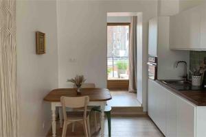 a kitchen with a wooden table and a dining room at Appartement centre ville avec terrasse in Lille