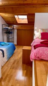 a bedroom with two beds and a skylight at Rincón Estelles in Estella