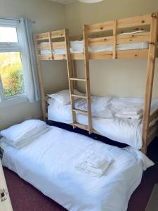 two bunk beds in a dorm room at 15 The Drive, Penstowe Holiday Park, Kilkhampton, Bude, Cornwall in Bude