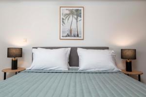 a bedroom with a bed with two lamps at Cozy Central Stay - 3 min Walk to Beach & Town - I in Kos