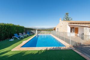 a swimming pool in the yard of a house at Son March I in Sa Pobla
