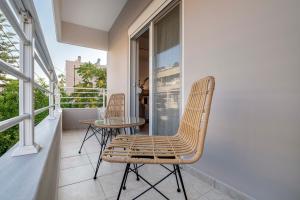 a patio with two chairs and a table on a balcony at Cozy Central Stay - 3 min Walk to Beach & Town - I in Kos +22 photos