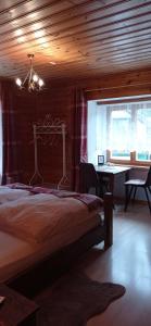 a bedroom with a bed and a table in a room at Gasthof Zum Lugauer in Radmer an der Hasel