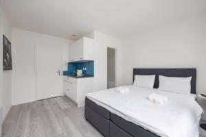 a bedroom with a large white bed with two towels at Urban Oasis with Queen Bed and View BE-44 in Zürich