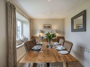 a dining room with a wooden table and chairs at 2 Bed in Satterthwaite and Grizedale LLH49 in Grizedale