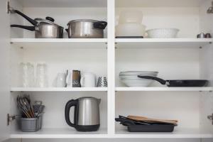 a kitchen shelves with pots and pans and utensils at Urban Oasis with Queen Bed and View BE-29 in Zürich