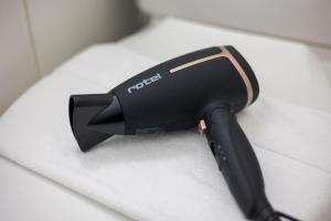 a hair dryer sitting on top of a table at Urban Oasis with Queen Bed and View BE-29 in Zürich +5 photos