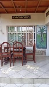 a dining room table and chairs in a house at COLIBRI VILLA 3 ROOMS in Gisenyi