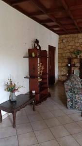 a living room with a table and a chair at COLIBRI VILLA 3 ROOMS in Gisenyi