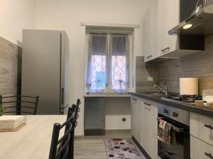 a kitchen with a counter and a window and a sink at Station House in Lido di Ostia