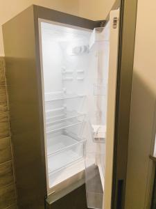 an empty refrigerator with its door open at Station House in Lido di Ostia