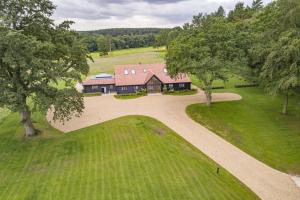 an overhead view of a house with a driveway and trees at Wild Meadow Barn in Aylsham