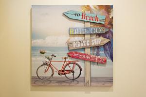 a picture of a sign with a bike on the beach at Blue Peacock in Faro