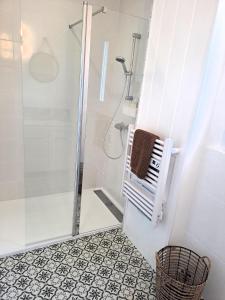 a bathroom with a shower with a glass door at Villa bord de mer avec piscine et jacuzzi in Pénestin