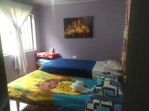 En eller flere senge i et værelse på Hospedaje Roca Firme