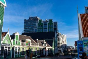 a group of buildings with a tall building in the background at easyHotel Amsterdam Zaandam in Zaandam