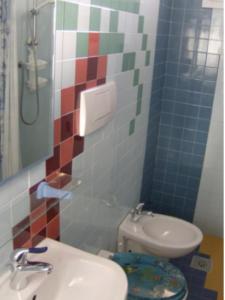 a bathroom with a sink and a toilet in it at Apartment Euroholiday 7R in Lido di Jesolo