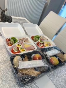 drie plastic verpakkingen van levensmiddelen op tafel bij AboutArtApartments - Młyn Maria in Wrocław